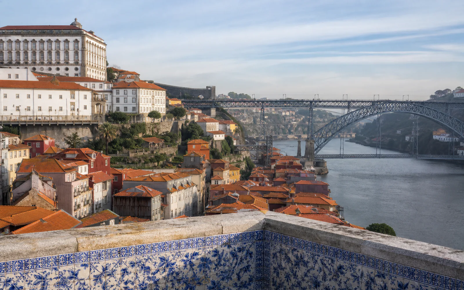 Porto’s Ribeira, the Douro River, and Dom Luís I Bridge above blue azulejo tiles