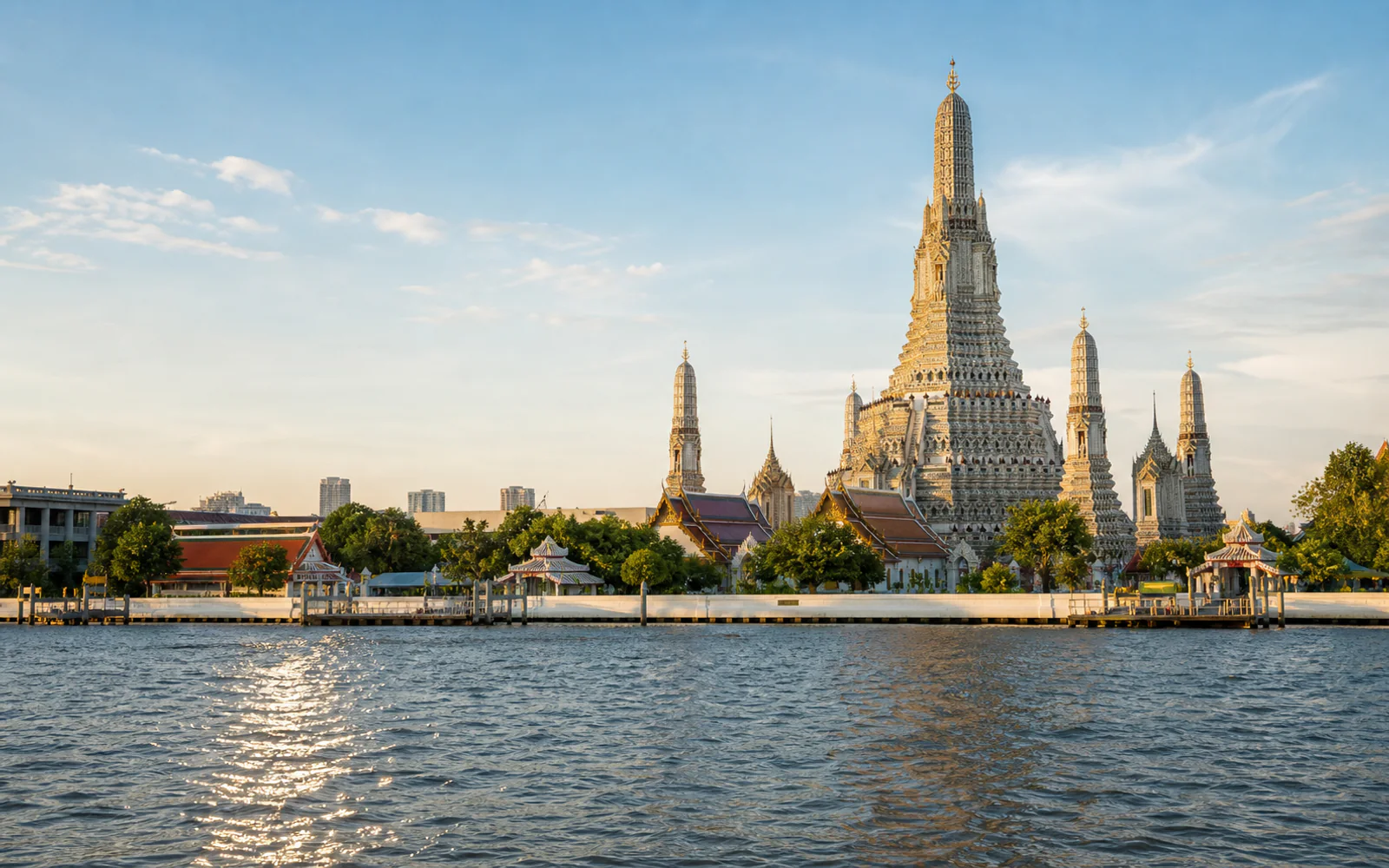 Wat Arun beside the Chao Phraya River in Bangkok in warm daylight